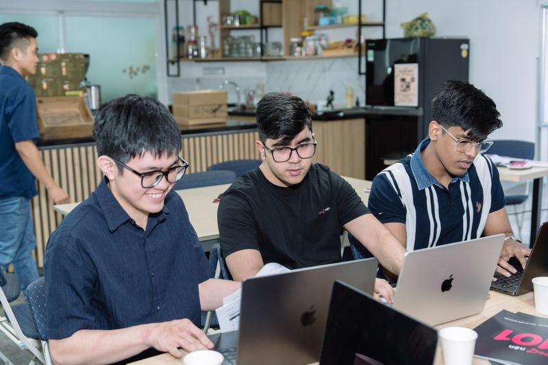 Anshul and two builders at their laptops